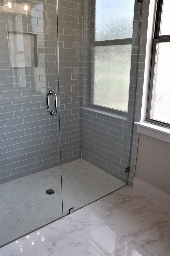 Example of a trendy master multicolored tile and marble tile marble floor and multicolored floor bathroom design in Austin with shaker cabinets, gray cabinets, gray walls, a vessel sink, quartz countertops and a hinged shower door