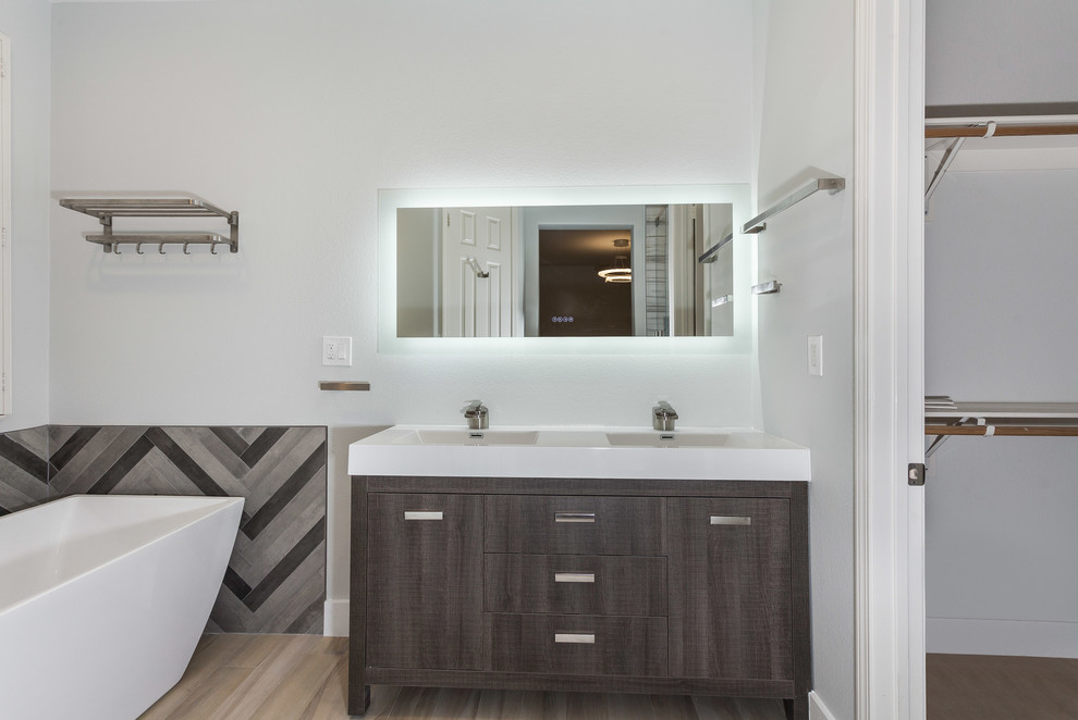Photo of a small contemporary shower room bathroom in Los Angeles with flat-panel cabinets, light wood cabinets, a freestanding bath, an alcove shower, a one-piece toilet, brown tiles, ceramic tiles, brown walls, mosaic tile flooring, a built-in sink, quartz worktops, brown floors, a sliding door and white worktops.