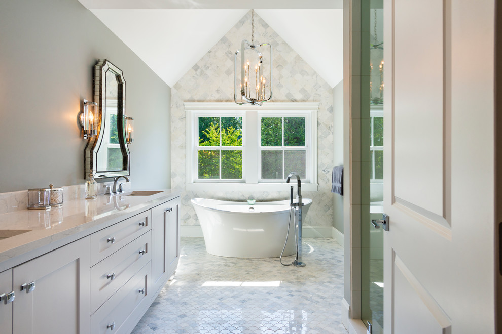 Mid-sized transitional master white tile and porcelain tile marble floor and gray floor bathroom photo in Other with shaker cabinets, white cabinets, a two-piece toilet, gray walls, an undermount sink, quartz countertops, a hinged shower door and white countertops