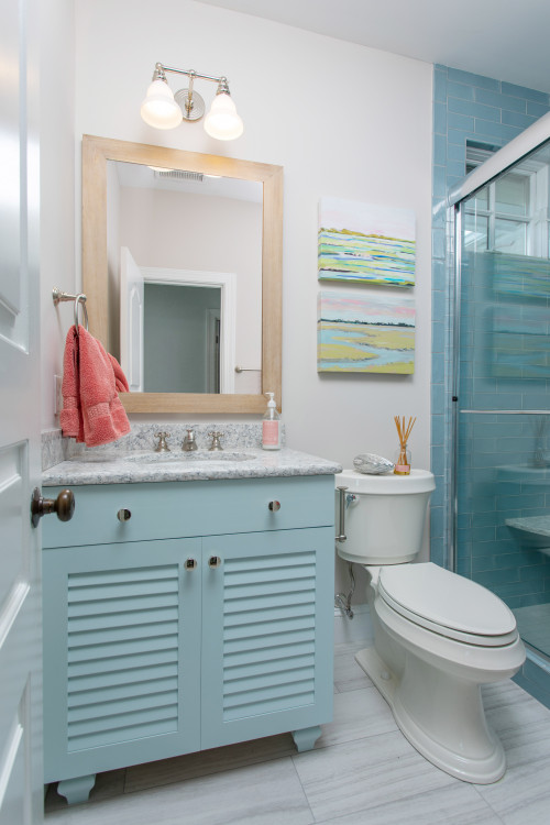 Pastel Coastal Serenity: Small Bathroom Design with Pastel Blue Vanity and Wood Mirror