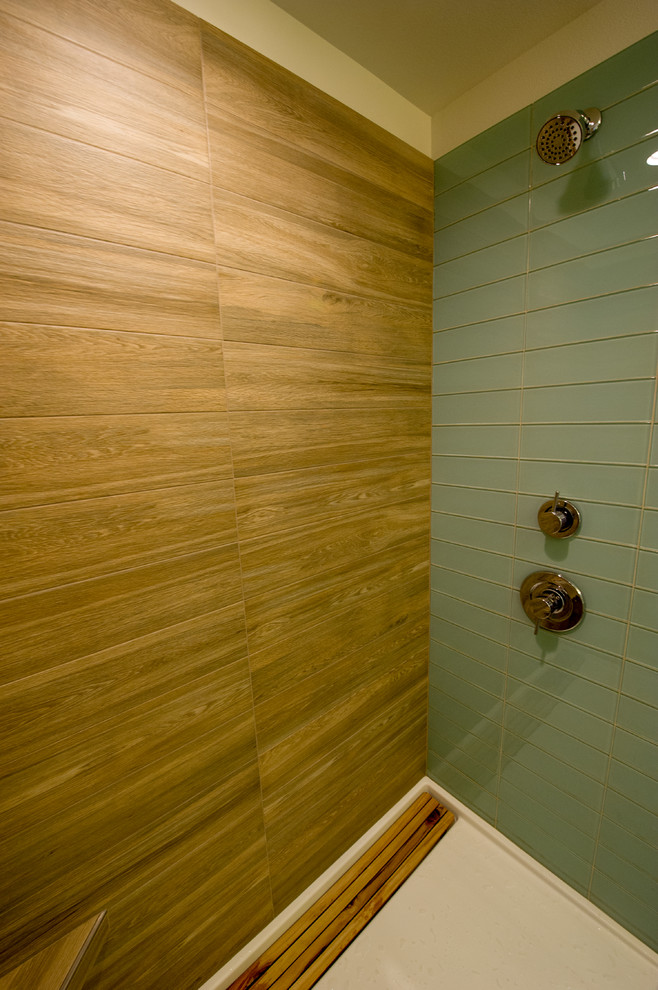 Inspiration for a mid-sized modern master green tile ceramic tile and gray floor double shower remodel in Portland with flat-panel cabinets, dark wood cabinets, a wall-mount toilet, white walls, an undermount sink, quartzite countertops and a hinged shower door