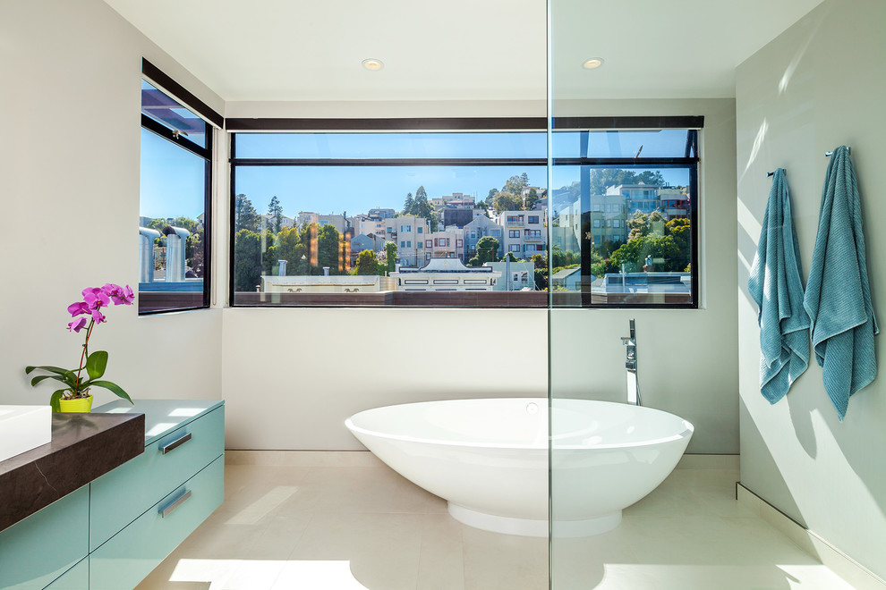 Inspiration for a mid-sized contemporary master porcelain tile bathroom remodel in San Francisco with a vessel sink, flat-panel cabinets, marble countertops and a two-piece toilet
