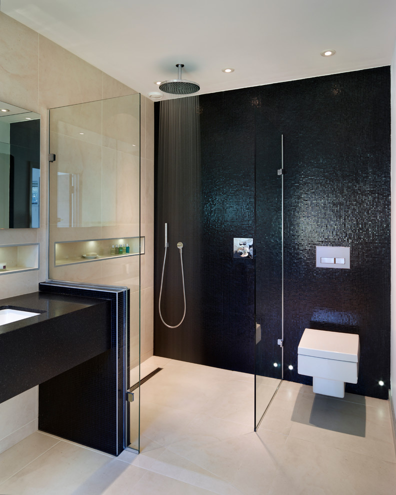 This is an example of a contemporary bathroom in Surrey with a submerged sink, a walk-in shower, a wall mounted toilet, black tiles, mosaic tiles and an open shower.