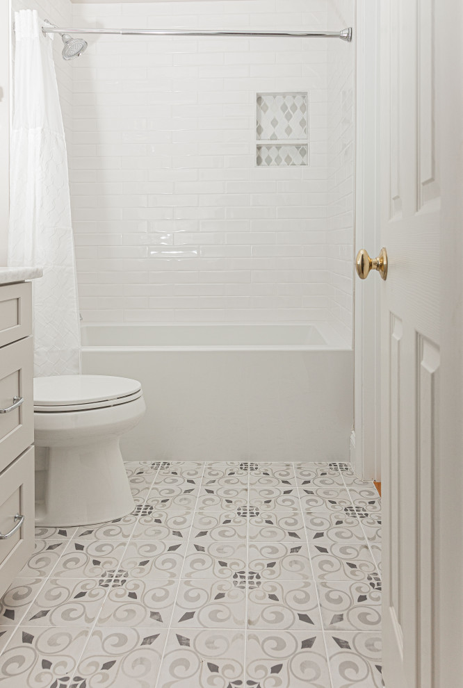Bathroom - small contemporary 3/4 white tile and porcelain tile porcelain tile and single-sink bathroom idea in Atlanta with shaker cabinets, gray cabinets, a two-piece toilet, beige walls, an undermount sink, marble countertops, white countertops, a niche and a built-in vanity