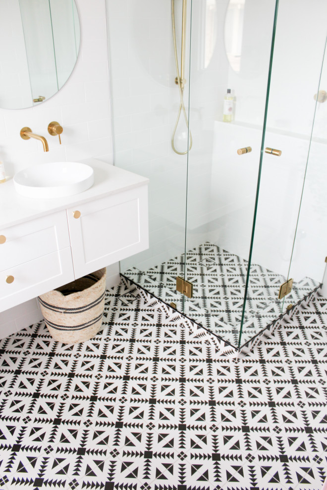 Exempel på ett mellanstort modernt vit vitt en-suite badrum, med skåp i shakerstil, vita skåp, en hörndusch, en toalettstol med hel cisternkåpa, vit kakel, keramikplattor, vita väggar, mosaikgolv, ett fristående handfat, bänkskiva i kvarts, flerfärgat golv och dusch med gångjärnsdörr