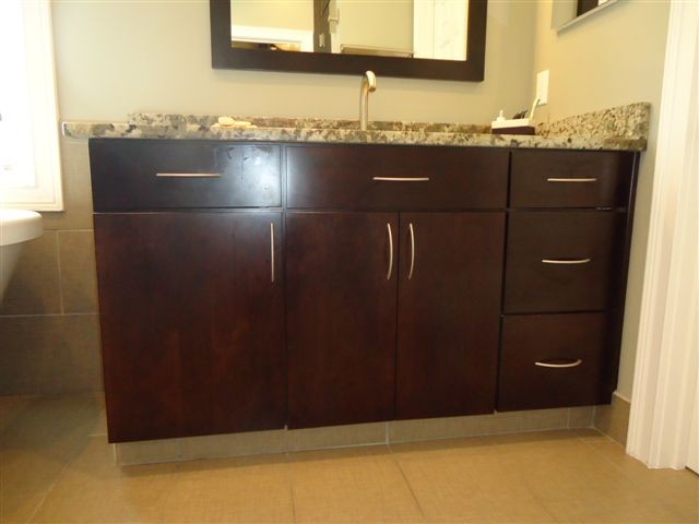 Inspiration for a modern ensuite bathroom in Indianapolis with flat-panel cabinets, dark wood cabinets, granite worktops, beige tiles, ceramic tiles, beige walls and ceramic flooring.