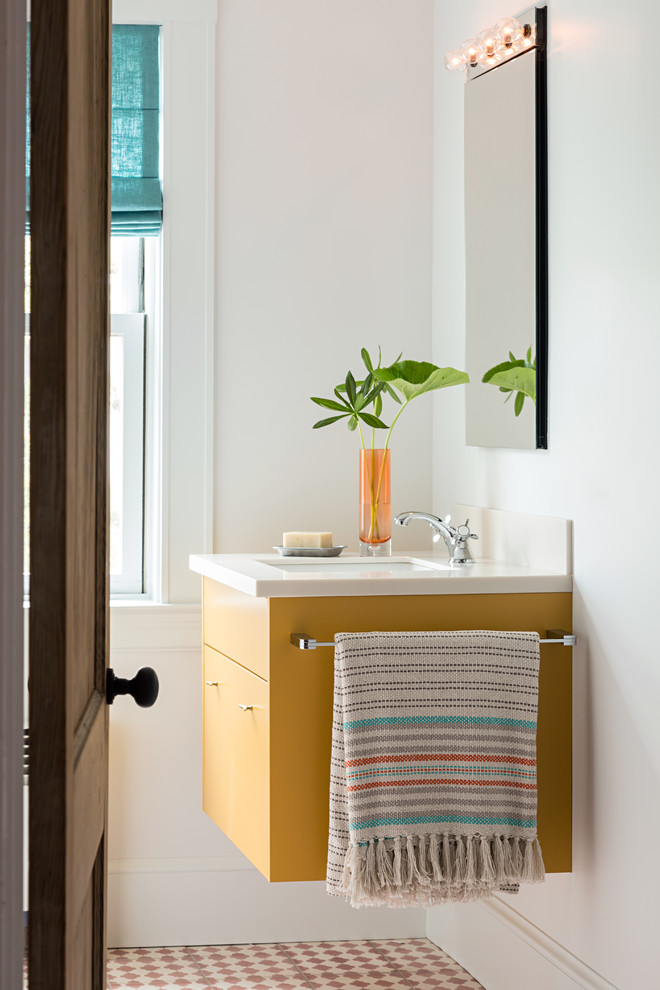 This is an example of a contemporary bathroom in Boston with yellow cabinets, cement tiles, white walls, a submerged sink and flat-panel cabinets.