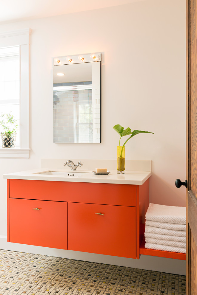 Идея дизайна: ванная комната в современном стиле с оранжевыми фасадами, белыми стенами, полом из керамической плитки, врезной раковиной, плоскими фасадами и зеркалом с подсветкой