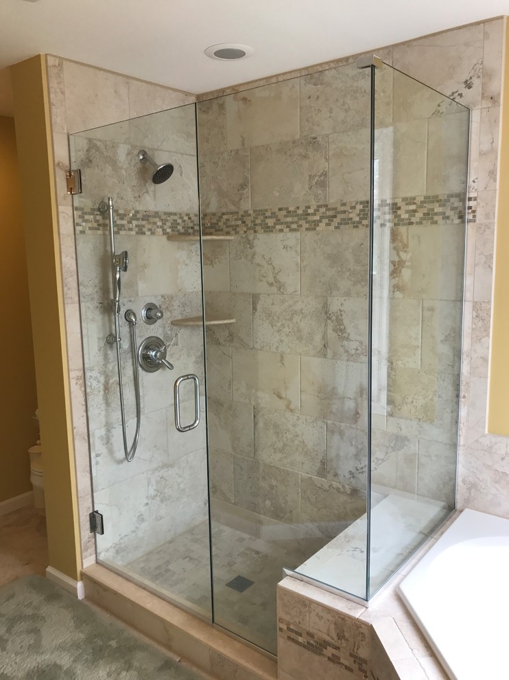 Large traditional ensuite bathroom in Baltimore with shaker cabinets, light wood cabinets, a corner bath, a walk-in shower, a two-piece toilet, beige tiles, ceramic tiles, yellow walls, ceramic flooring, a submerged sink, granite worktops, beige floors and a hinged door.