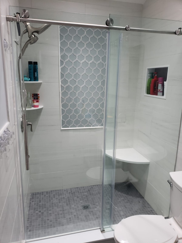 Example of a mid-sized minimalist master white tile and porcelain tile porcelain tile and double-sink bathroom design in New York with shaker cabinets, white cabinets, a one-piece toilet, white walls, an undermount sink, quartzite countertops, white countertops and a built-in vanity