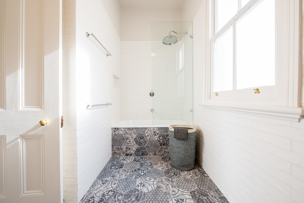Example of a mid-sized transitional multicolored tile porcelain tile bathroom design in Melbourne with recessed-panel cabinets, white cabinets, quartz countertops, an undermount sink and a wall-mount toilet