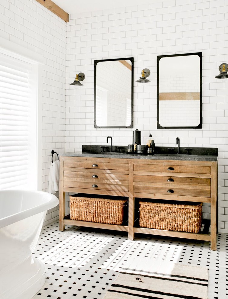 На фото: большая главная ванная комната в стиле кантри с коричневыми фасадами, отдельно стоящей ванной, белой плиткой, керамической плиткой, полом из мозаичной плитки, столешницей из гранита, белым полом и плоскими фасадами с