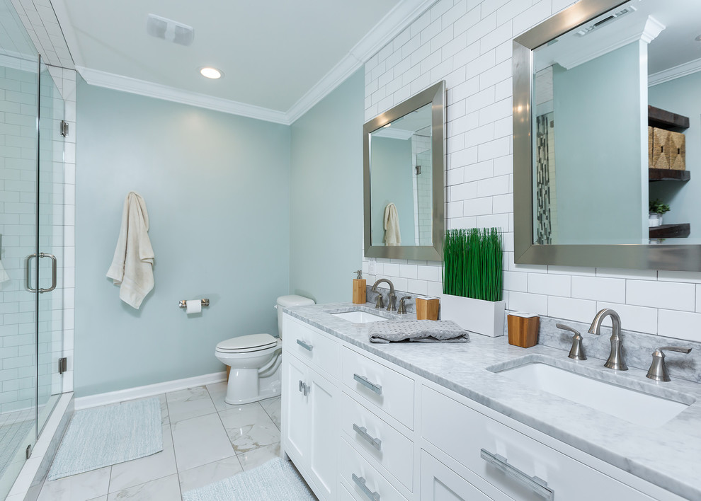 Small trendy master white tile and porcelain tile porcelain tile walk-in shower photo in Miami with shaker cabinets, white cabinets, a one-piece toilet, blue walls, an undermount sink and marble countertops