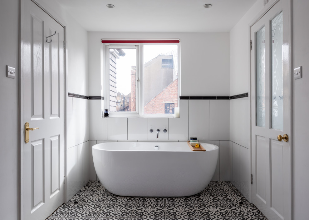 Inspiration for a small contemporary ensuite bathroom in London with a freestanding bath, white walls, white tiles and multi-coloured floors.
