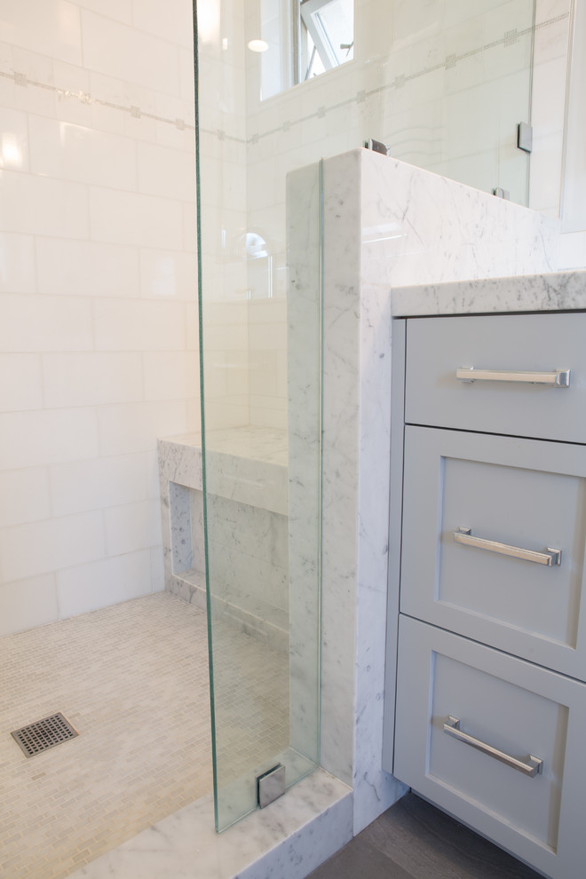 Design ideas for a medium sized contemporary ensuite bathroom in Los Angeles with shaker cabinets, grey cabinets, a freestanding bath, a double shower, a one-piece toilet, white tiles, stone tiles, grey walls, porcelain flooring and a submerged sink.