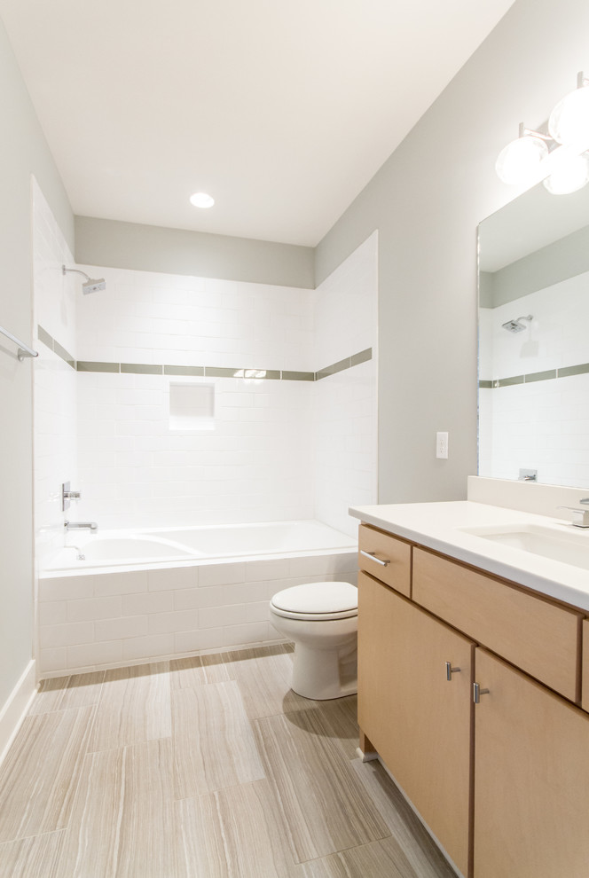 Bathroom - small transitional 3/4 white tile and subway tile porcelain tile bathroom idea in Nashville with flat-panel cabinets, light wood cabinets, a two-piece toilet, gray walls, an undermount sink and quartz countertops