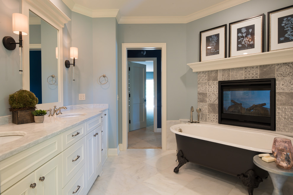 Photo of a medium sized traditional ensuite bathroom in Minneapolis with recessed-panel cabinets, white cabinets, a claw-foot bath, an alcove shower, a one-piece toilet, blue walls, ceramic flooring, a submerged sink, granite worktops, beige floors and a hinged door.