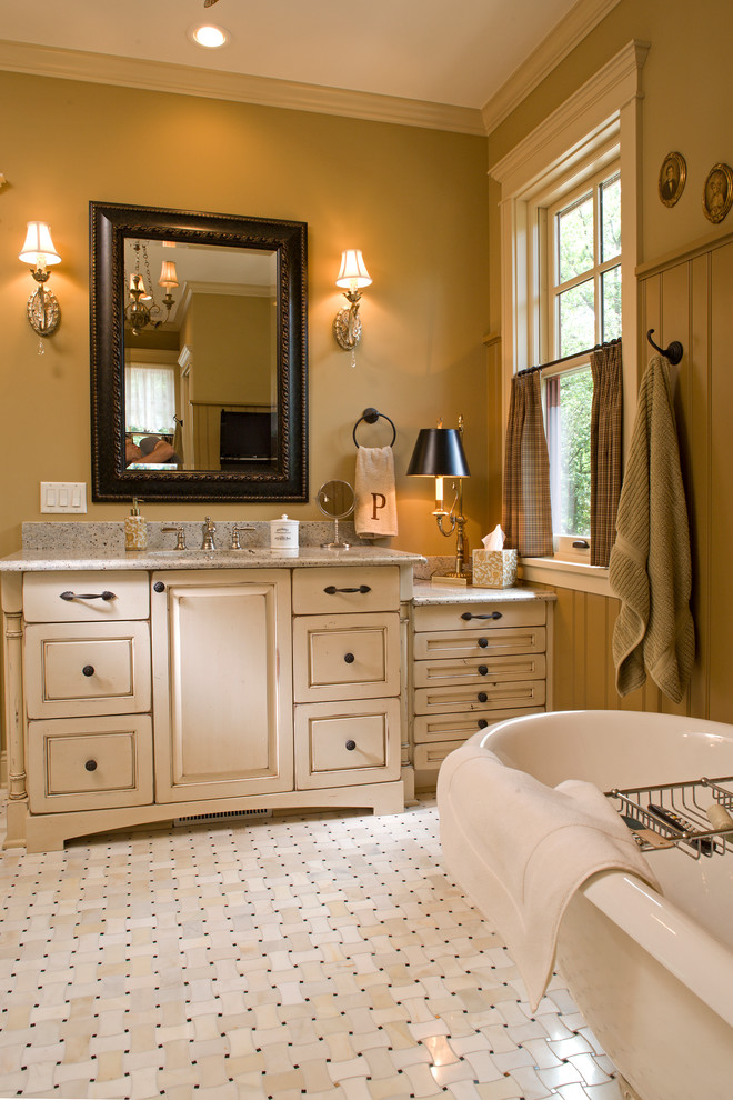 Mid-sized elegant master ceramic tile alcove shower photo in Minneapolis with raised-panel cabinets, distressed cabinets, a one-piece toilet, green walls, an undermount sink and granite countertops