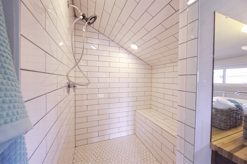 Exempel på ett stort klassiskt en-suite badrum, med luckor med infälld panel, bruna skåp, en dusch i en alkov, en toalettstol med separat cisternkåpa, vit kakel, keramikplattor, vita väggar, cementgolv, ett fristående handfat, träbänkskiva, grått golv och dusch med gångjärnsdörr