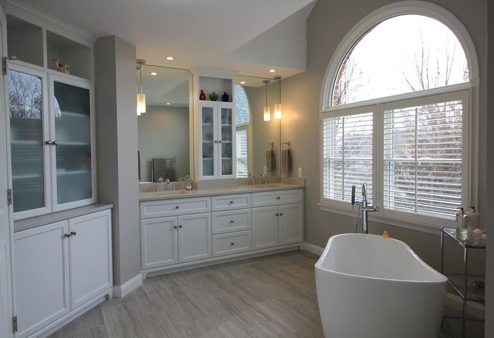 Design ideas for a large classic ensuite bathroom in DC Metro with shaker cabinets, white cabinets, a freestanding bath, an alcove shower, a two-piece toilet, porcelain tiles, grey walls, porcelain flooring, a submerged sink, solid surface worktops, grey floors and a hinged door.
