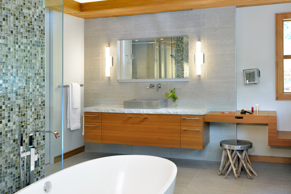 Photo of an expansive eclectic ensuite bathroom in Toronto with flat-panel cabinets, dark wood cabinets, engineered stone worktops, a freestanding bath, beige tiles, porcelain tiles and porcelain flooring.