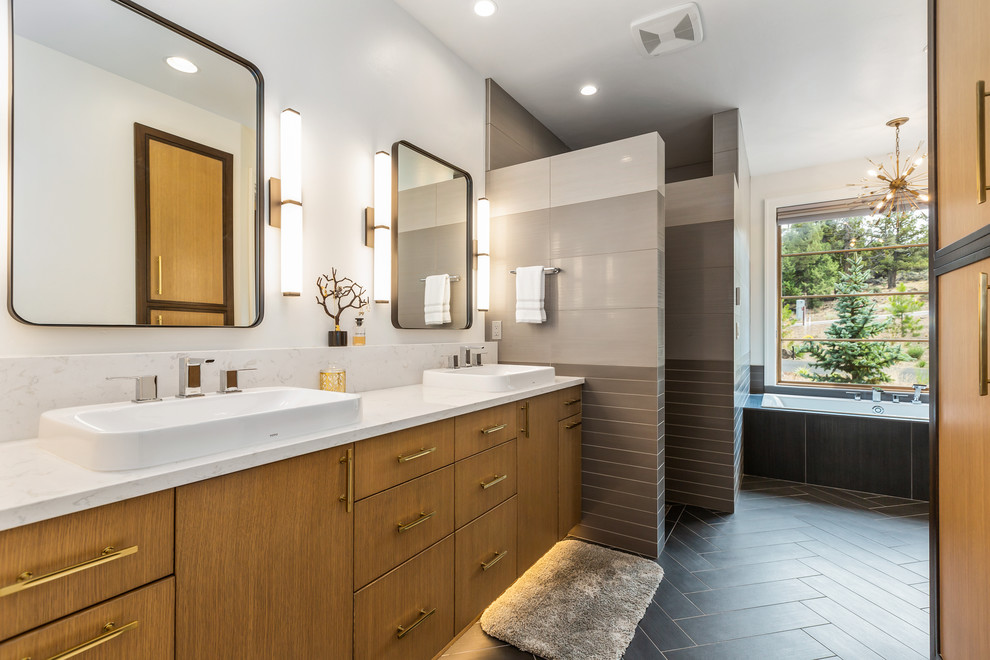 This is an example of a mid-sized contemporary master bathroom in Other with flat-panel cabinets, a drop-in tub, gray tile, ceramic tile, white walls, cement tiles, a vessel sink, engineered quartz benchtops, grey floor, white benchtops and light wood cabinets.