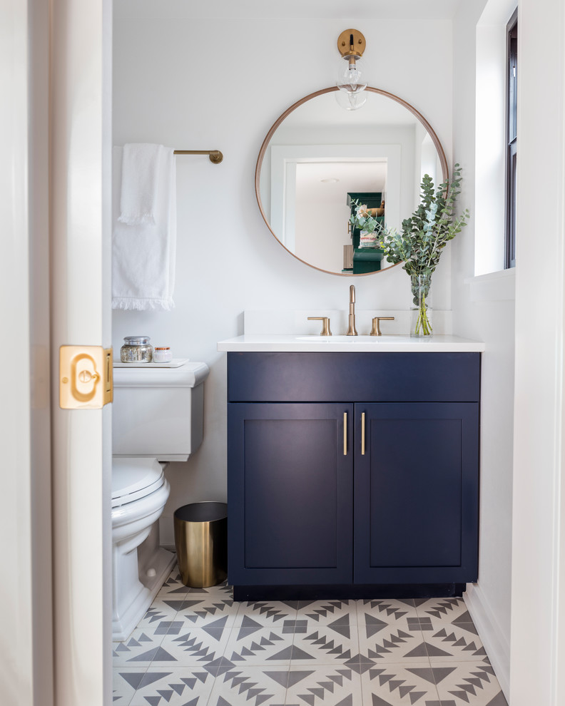 Example of a small danish master cement tile floor and multicolored floor bathroom design in Seattle with shaker cabinets, blue cabinets, a two-piece toilet, white walls, an undermount sink and quartz countertops