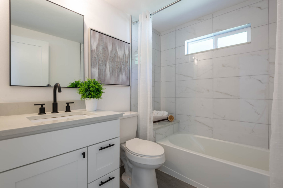 Small contemporary ensuite bathroom in Seattle with shaker cabinets, white cabinets, a built-in bath, a shower/bath combination, a two-piece toilet, white tiles, porcelain tiles, white walls, ceramic flooring, a submerged sink, engineered stone worktops, grey floors, a shower curtain, white worktops, a shower bench, a single sink and a built in vanity unit.