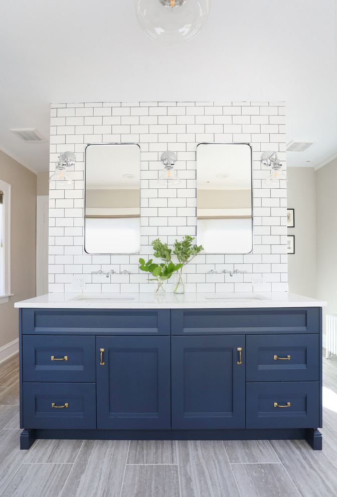 Example of a mid-sized transitional master white tile and ceramic tile porcelain tile and beige floor bathroom design in Chicago with recessed-panel cabinets, blue cabinets, beige walls, an undermount sink, quartz countertops and white countertops