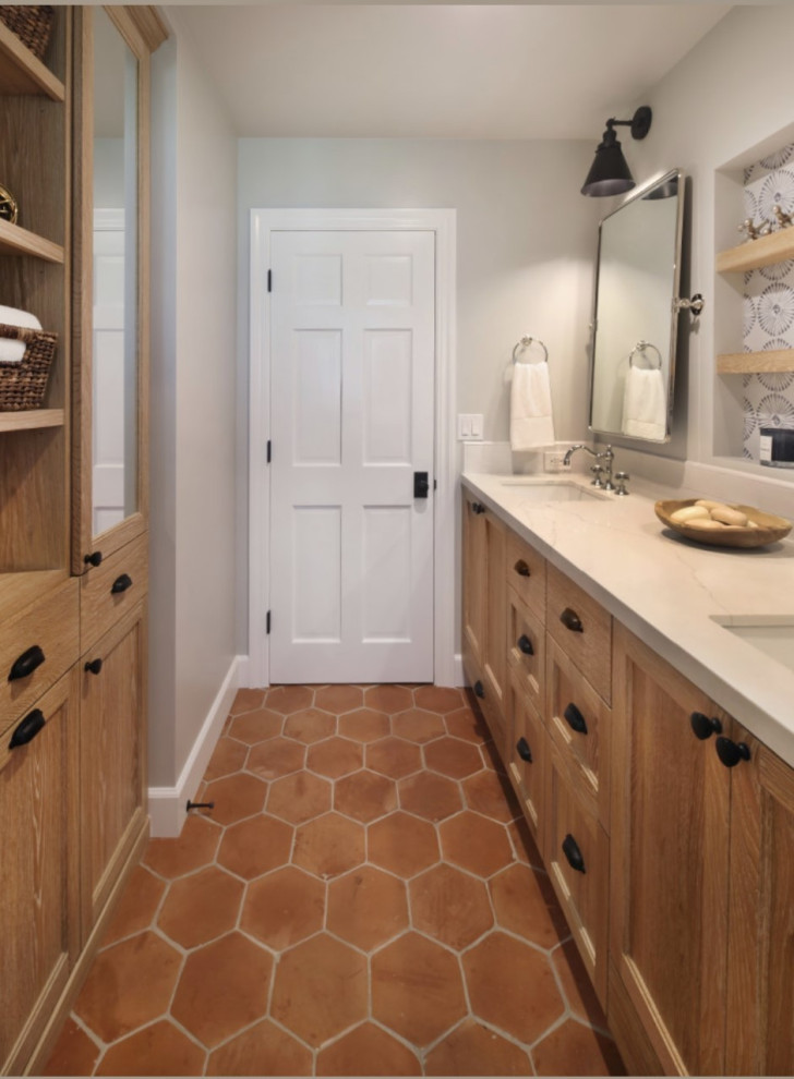 Photo of a medium sized farmhouse shower room bathroom in Orange County with shaker cabinets, light wood cabinets, an alcove bath, a shower/bath combination, blue tiles, terracotta tiles, grey walls, terracotta flooring, a submerged sink, engineered stone worktops, orange floors, a shower curtain, white worktops, double sinks and a built in vanity unit.