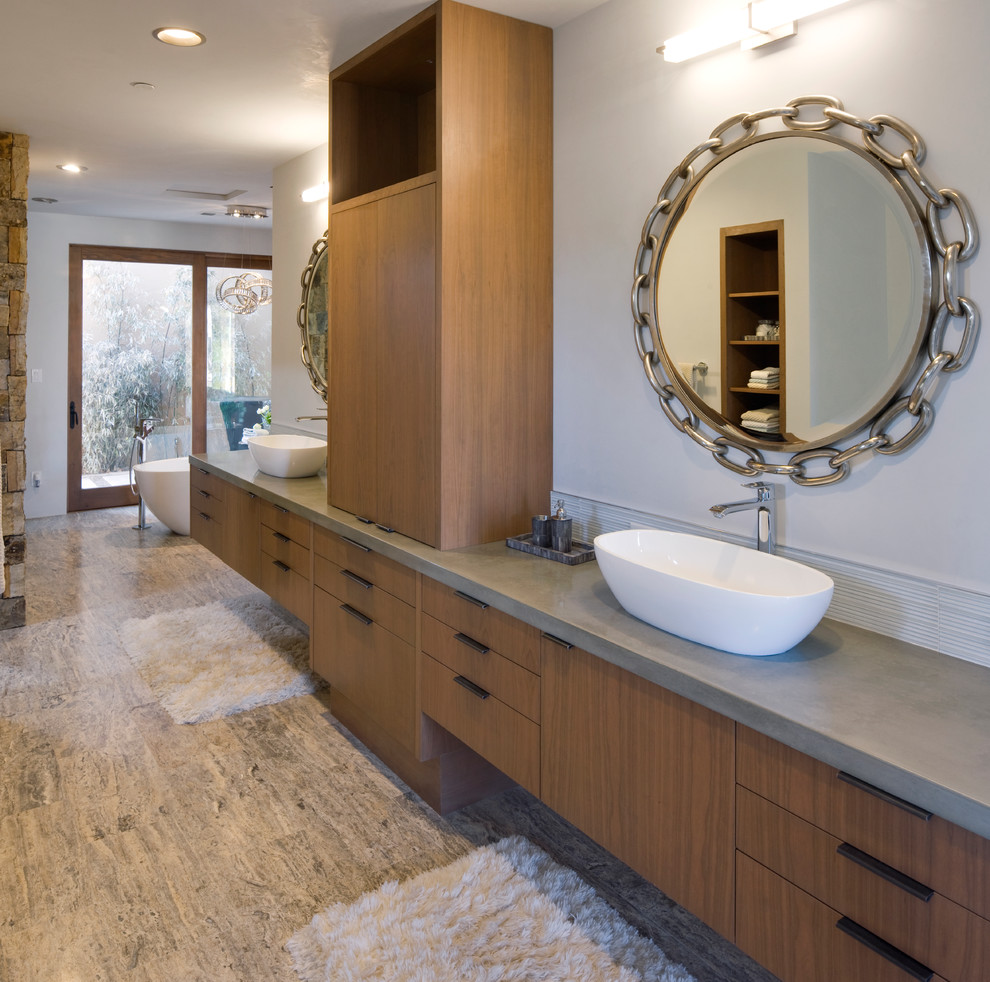Expansive classic ensuite bathroom in Albuquerque with flat-panel cabinets, dark wood cabinets, a freestanding bath, white walls, a vessel sink and concrete worktops.