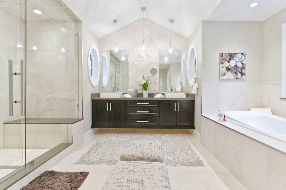 Example of a trendy beige tile bathroom design in Vancouver with a vessel sink, shaker cabinets and dark wood cabinets
