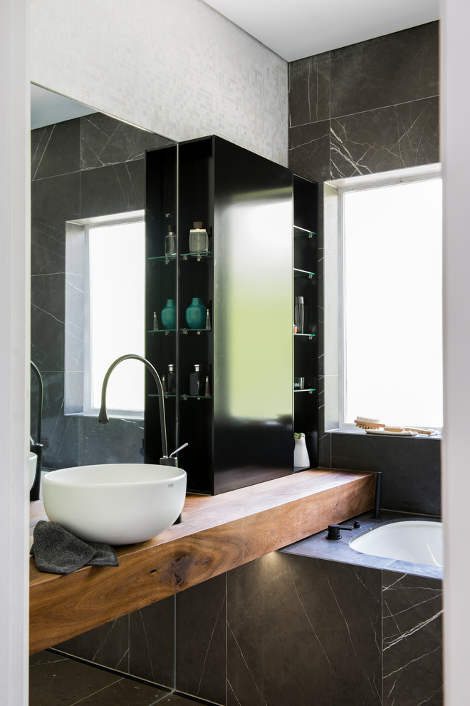 Inspiration for a small contemporary family bathroom in Sydney with freestanding cabinets, distressed cabinets, a submerged bath, a shower/bath combination, a wall mounted toilet, grey tiles, mosaic tiles, white walls, marble flooring, a vessel sink, wooden worktops, grey floors and an open shower.