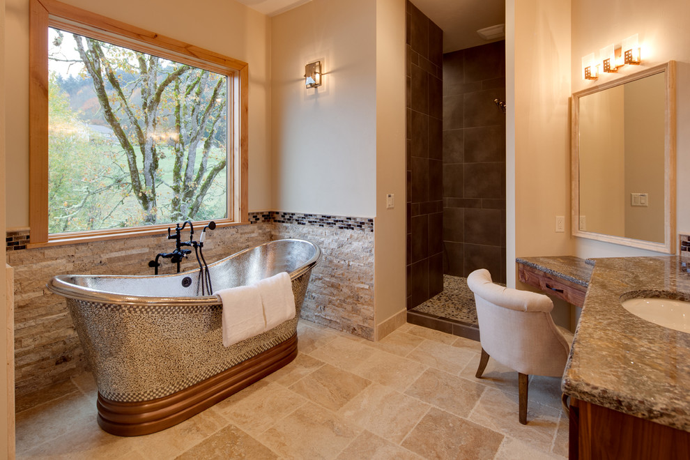 На фото: ванная комната в стиле рустика с врезной раковиной, темными деревянными фасадами, отдельно стоящей ванной, душем в нише и бежевой плиткой с
