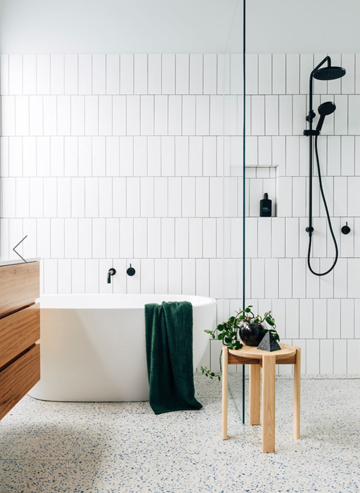 Photo of a contemporary bathroom in Melbourne with flat-panel cabinets, medium wood cabinets, a freestanding bath, a built-in shower, white tiles, white walls, white floors, an open shower and white worktops.