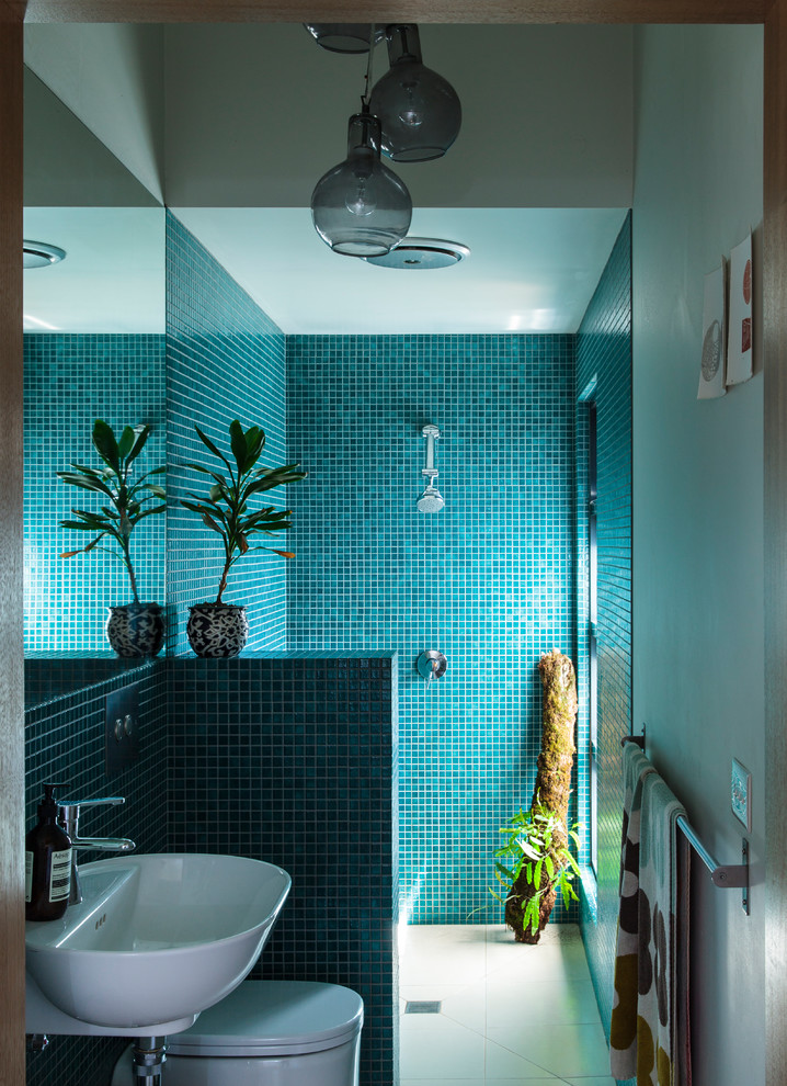 Example of a small trendy master green tile and mosaic tile ceramic tile doorless shower design in Melbourne with open cabinets, white cabinets, a wall-mount toilet, white walls, a wall-mount sink and tile countertops