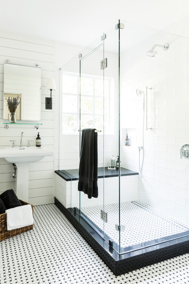 Inspiration for a mid-sized cottage white tile and porcelain tile porcelain tile and white floor doorless shower remodel in Dallas with shaker cabinets, white cabinets, a one-piece toilet, white walls, a pedestal sink, granite countertops, a hinged shower door and black countertops