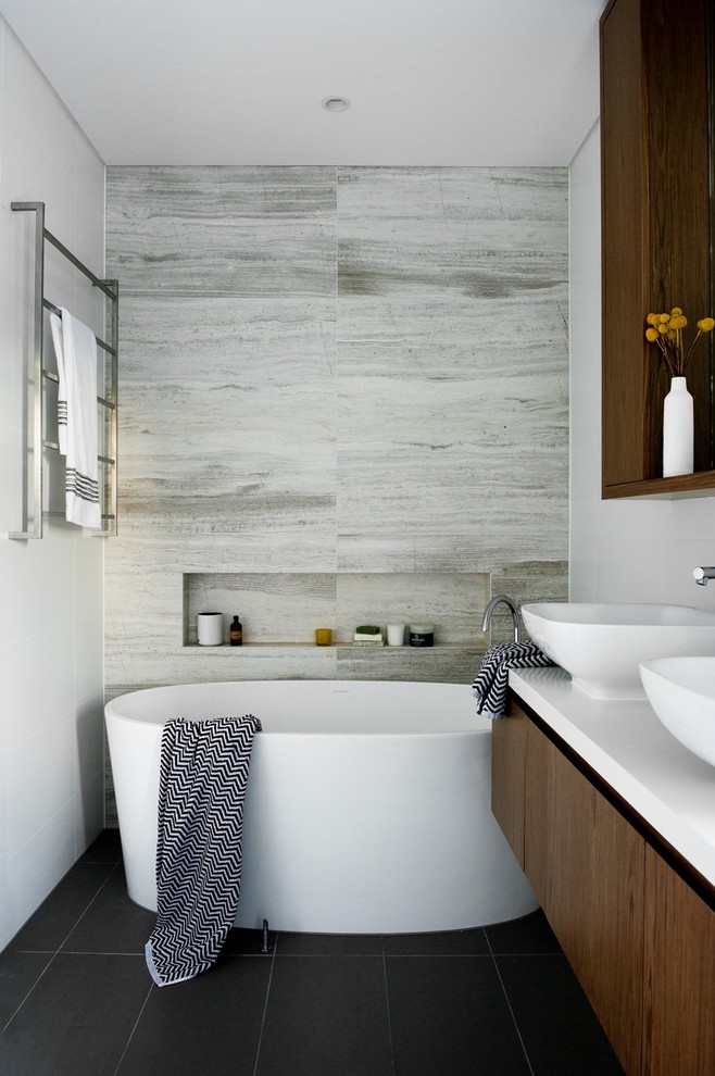 Design ideas for a medium sized modern bathroom in Sydney with dark wood cabinets, a freestanding bath and porcelain flooring.