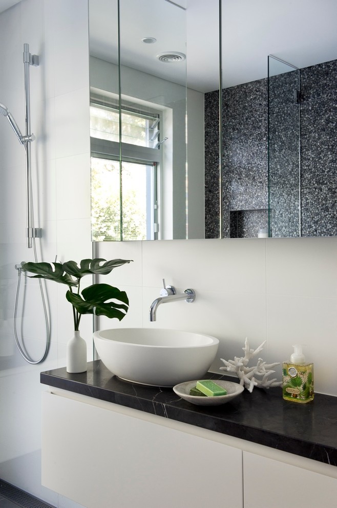 Inspiration for a medium sized modern bathroom in Sydney with dark wood cabinets, a freestanding bath, a walk-in shower and porcelain flooring.