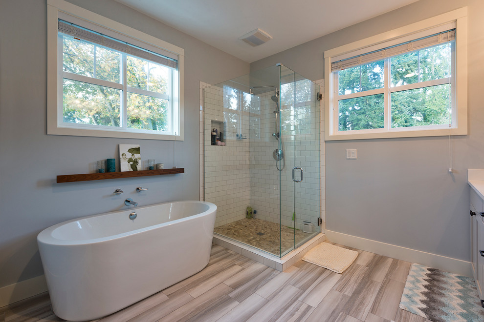 Example of a mid-sized trendy master gray tile and ceramic tile porcelain tile bathroom design in Seattle with shaker cabinets, gray cabinets, quartz countertops and gray walls