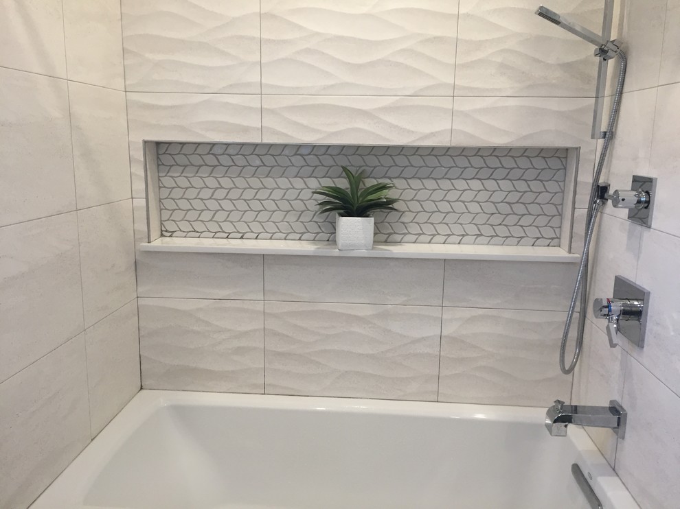 Photo of a small country bathroom in New York with flat-panel cabinets, grey cabinets, a built-in bath, a one-piece toilet, white tiles, mosaic tiles, ceramic flooring, solid surface worktops and beige floors.
