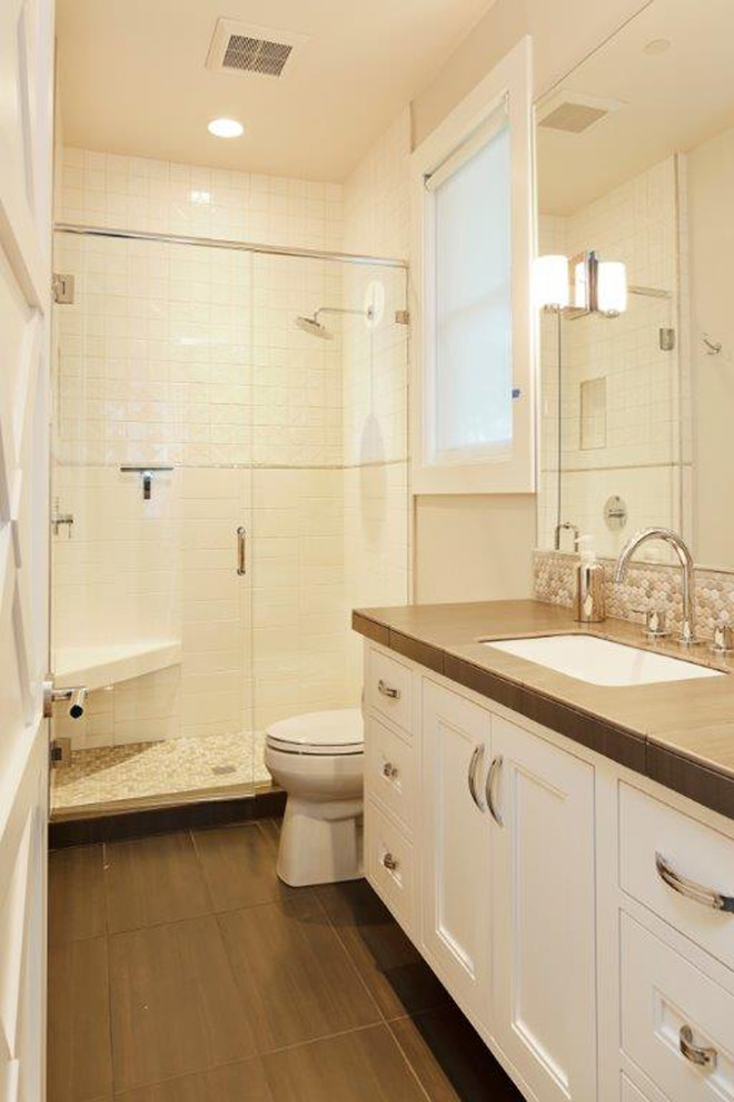Example of a trendy porcelain tile bathroom design in Portland with an undermount sink, recessed-panel cabinets, white cabinets and tile countertops