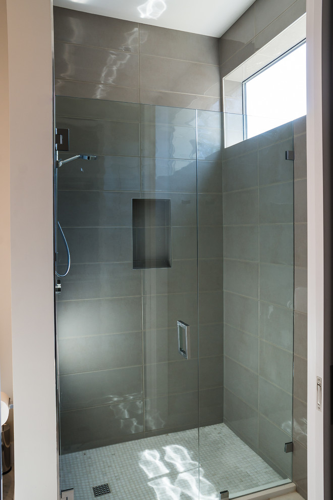Inspiration for a contemporary ensuite bathroom in Austin with flat-panel cabinets, grey cabinets, a built-in bath, an alcove shower, grey tiles, white tiles, matchstick tiles, vinyl flooring, an integrated sink and solid surface worktops.