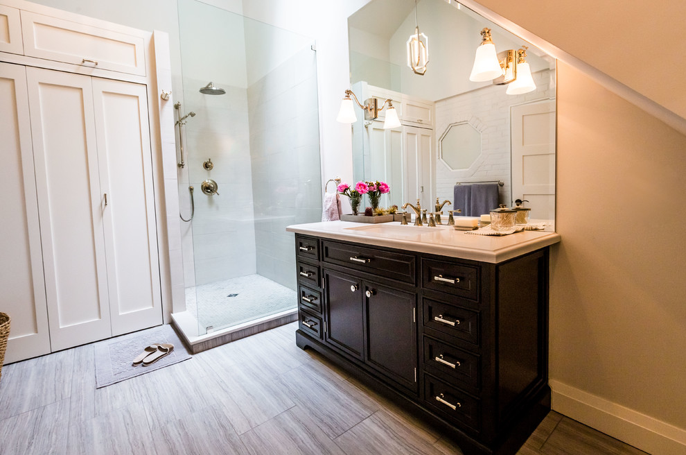 This is an example of a medium sized traditional shower room bathroom in Toronto with shaker cabinets, black cabinets, a corner shower, a one-piece toilet, beige tiles, porcelain tiles, grey walls, porcelain flooring, a submerged sink, onyx worktops and an open shower.