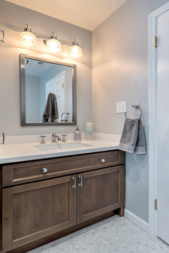 Medium sized classic bathroom in San Francisco with a submerged sink, shaker cabinets, medium wood cabinets, quartz worktops, an alcove bath, a shower/bath combination, a two-piece toilet, white tiles, metro tiles, grey walls and mosaic tile flooring.