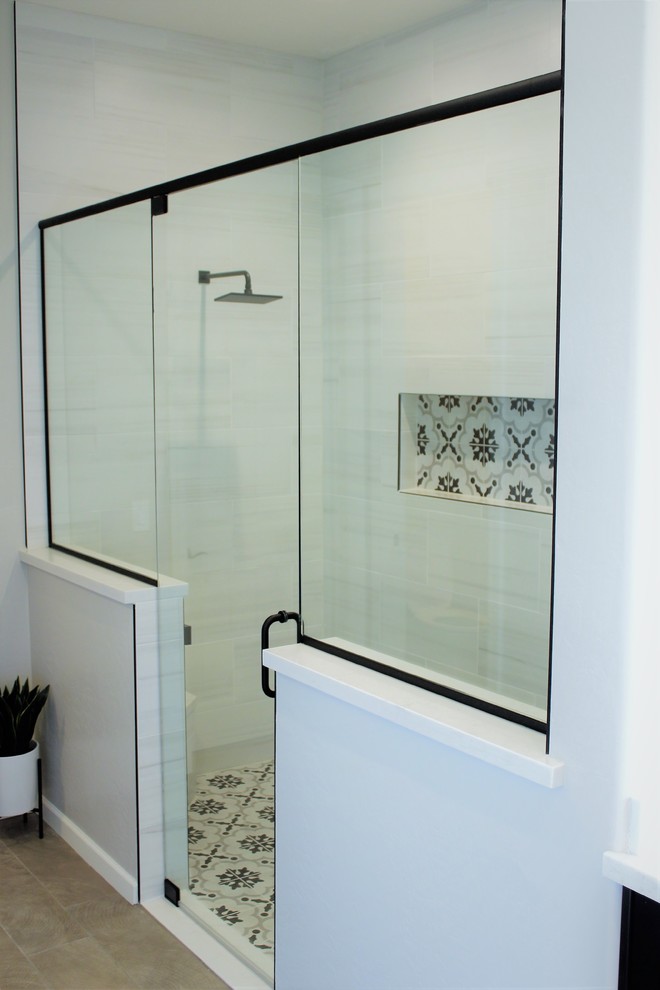 This is an example of a large modern ensuite bathroom in Phoenix with shaker cabinets, black cabinets, a built-in shower, a two-piece toilet, white tiles, ceramic tiles, white walls, porcelain flooring, a submerged sink, engineered stone worktops, brown floors and a hinged door.