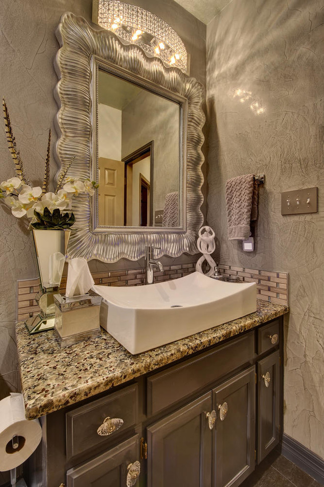 Inspiration for a small timeless beige tile and matchstick tile bathroom remodel in Austin with recessed-panel cabinets, distressed cabinets, a two-piece toilet, gray walls, a vessel sink, granite countertops and multicolored countertops