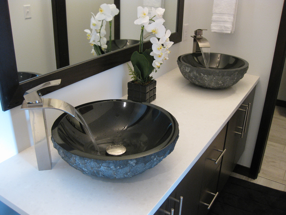 Example of a mid-sized trendy master bathroom design in Phoenix with flat-panel cabinets, dark wood cabinets, a vessel sink and quartzite countertops