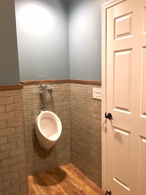 This is an example of a medium sized rustic cloakroom in Detroit with vinyl flooring.