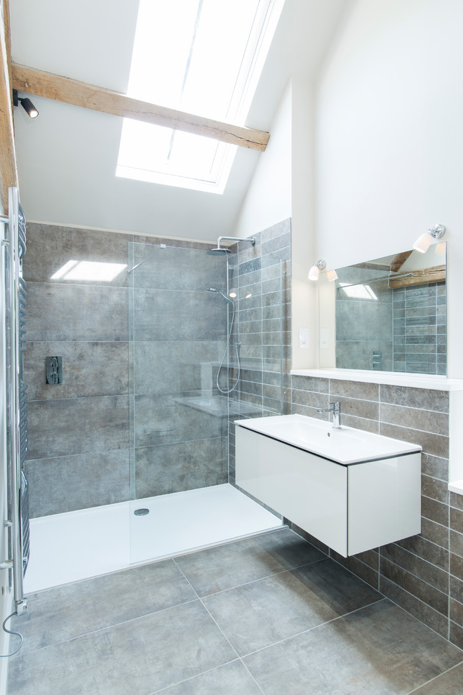 Idéer för lantliga vitt badrum med dusch, med släta luckor, vita skåp, en kantlös dusch, grå kakel, vita väggar, ett konsol handfat, grått golv och med dusch som är öppen